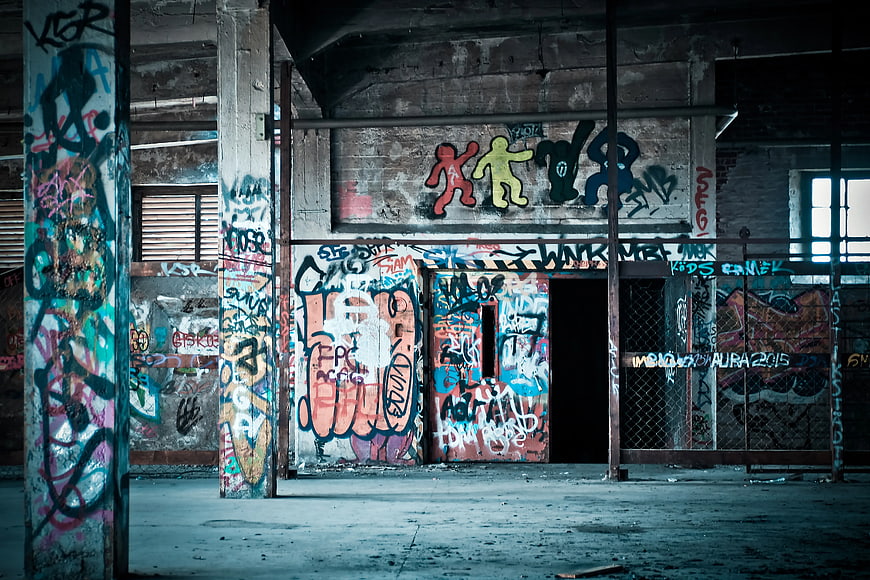 Colorful graffiti art in abandoned industrial warehouse interior