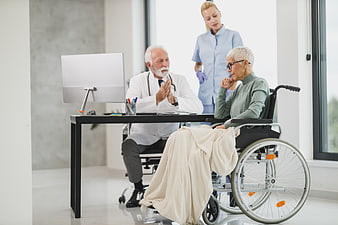 Senior Doctor Consulting Elderly Patient in Wheelchair