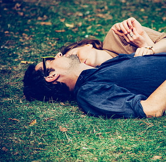 Couple Sleeping on Grass in Park