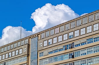 Modern Hospital Building Exterior With Blue Sky And Clouds