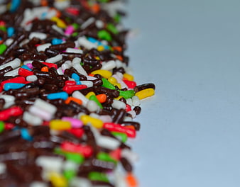 Colorful Sprinkles On Chocolate Coated Bar Close Up