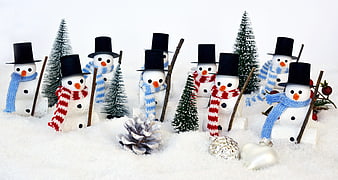 Cute Miniature Snowmen with Scarves and Hats in Snow