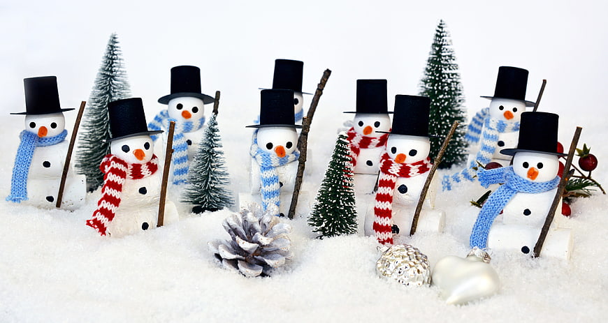 Cute Miniature Snowmen with Scarves and Hats in Snow