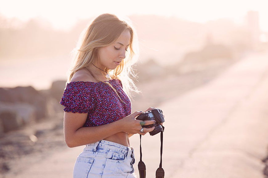 Woman Photographer Reviewing Camera Photos Outdoors