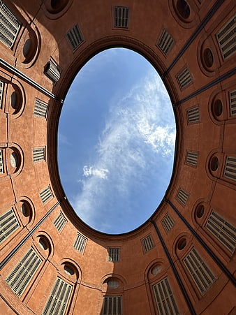 Low angle view of circular terracotta courtyard architecture