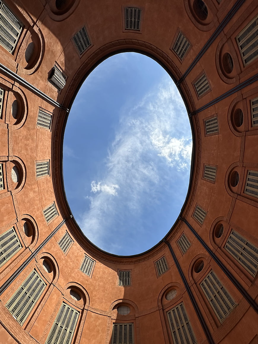 Low angle view of circular terracotta courtyard architecture