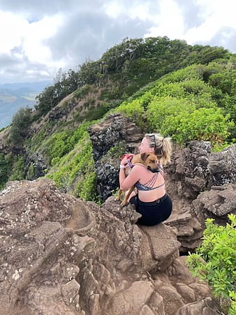 Woman Hiking with Dog on Rocky Mountain Summit