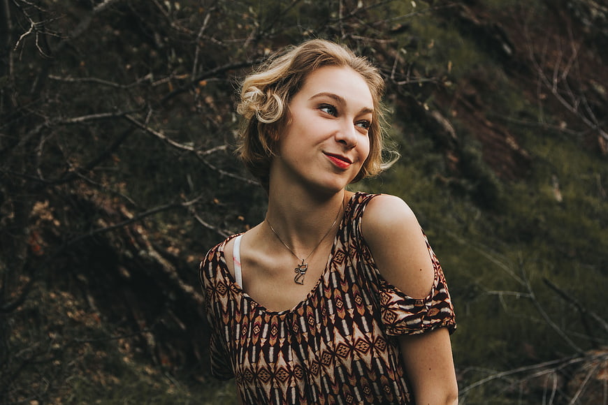 Smiling Blonde Woman in Patterned Top Outdoors