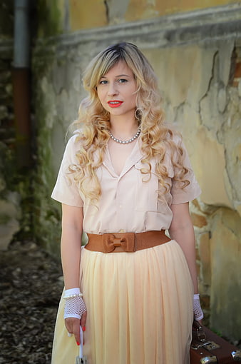 Retro Style Blonde Woman with Curls and Vintage Suitcase