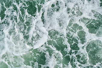 Aerial View of Green Ocean Waves and White Sea Foam