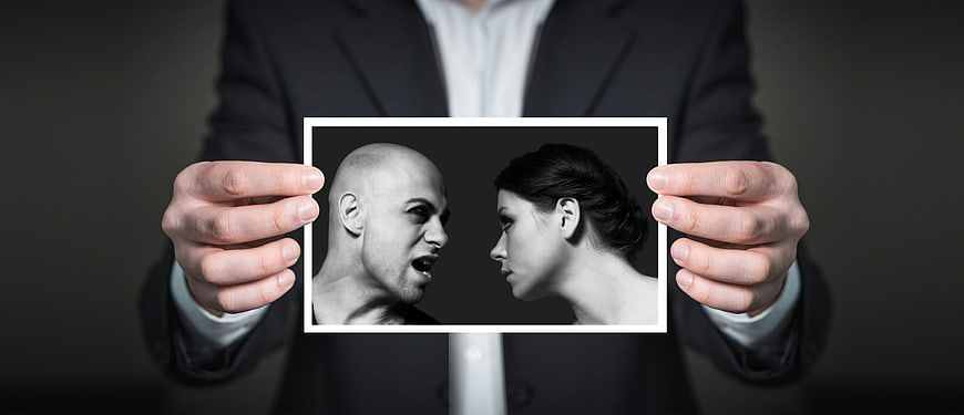 Businessman holding photo of arguing couple in black and white
