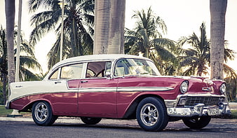 Classic Red and White 1950s American Car Parked by Palm Trees