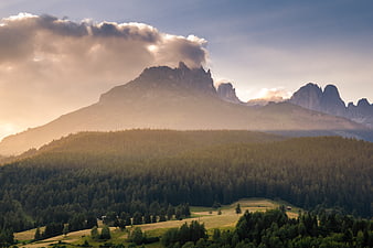 Majestic Mountain Peaks with Forest and Golden Sunset Light