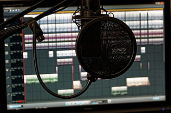 Professional Microphone with Pop Filter in Recording Studio