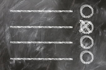 Hand-drawn chalk checklist with one item checked on dark blackboard background