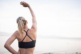Woman stretching outdoors with large copy space