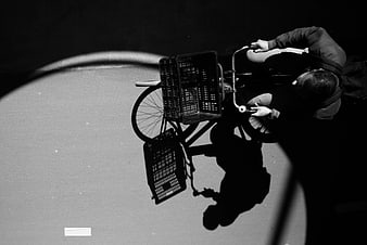 High Angle Black and White Photo of Man on Bicycle