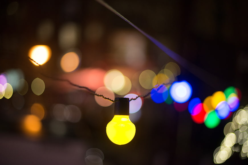 Yellow Christmas Light Bulb with Bokeh Background