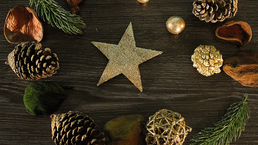 Christmas Star and Pine Cones on Dark Wood Background