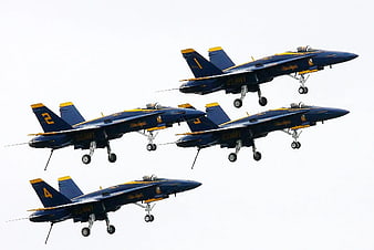 US Navy Blue Angels jets in tight diamond formation flight