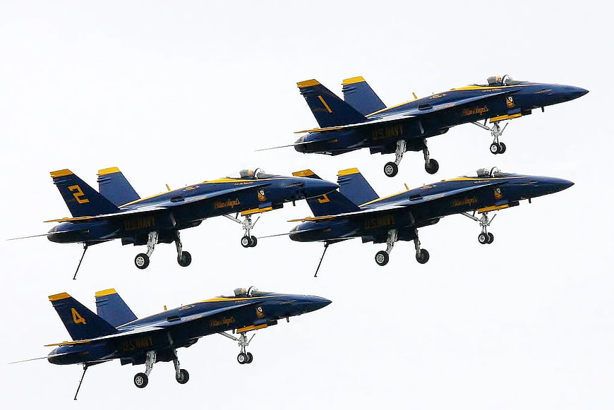 US Navy Blue Angels jets in tight diamond formation flight