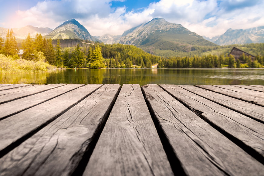Wooden Dock Leading to Mountain Lake Landscape