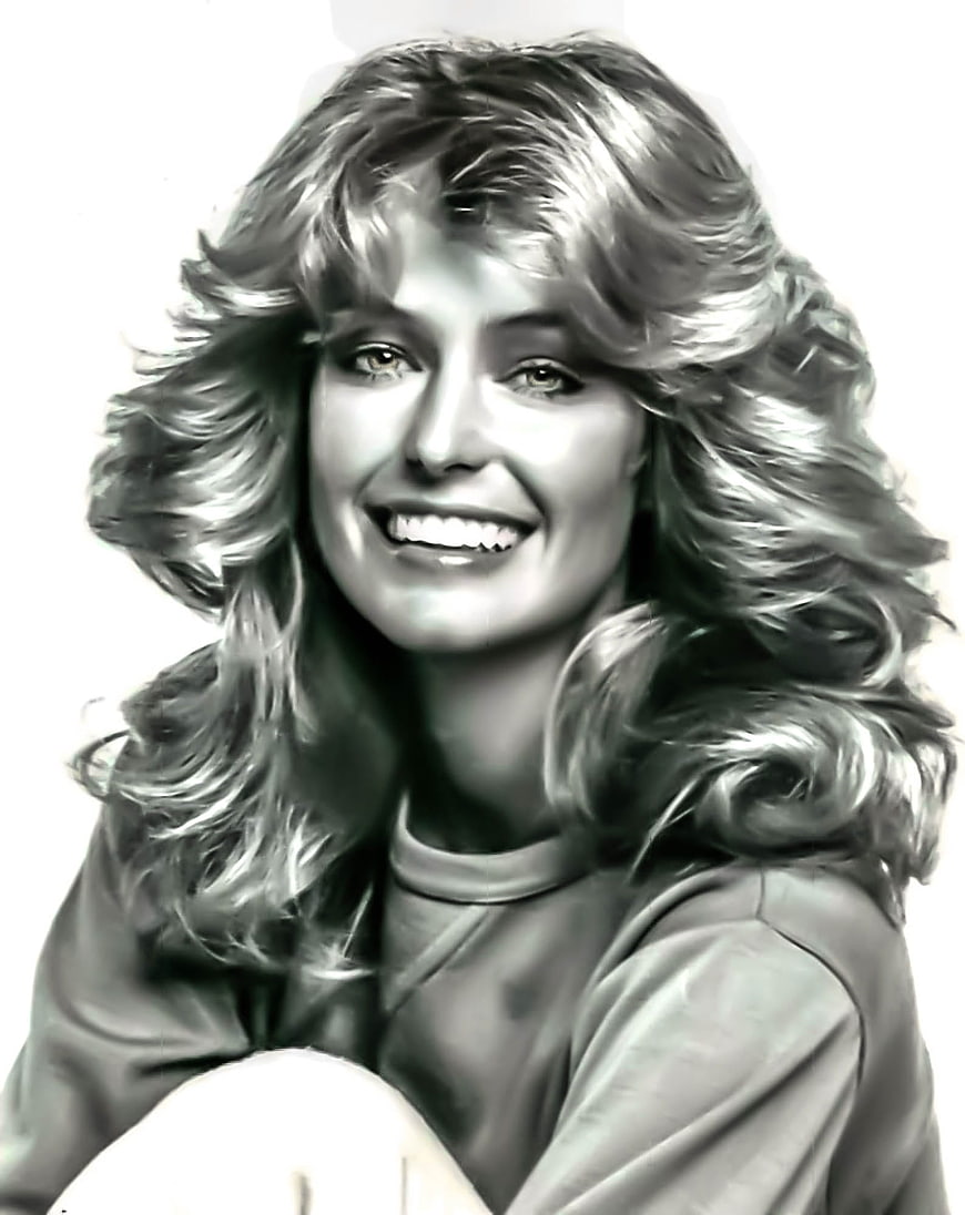 Black and white portrait of smiling woman with voluminous 1970s hair
