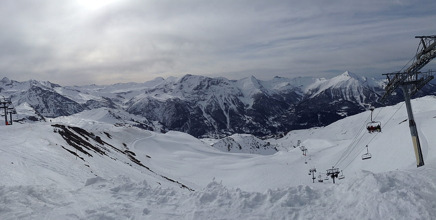 Panoramic View of Snowy Mountain Ski Resort with Chairlift