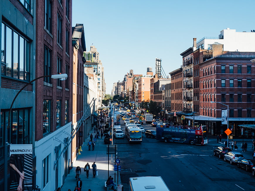 Busy City Street Scene with Brick Buildings and Traffic