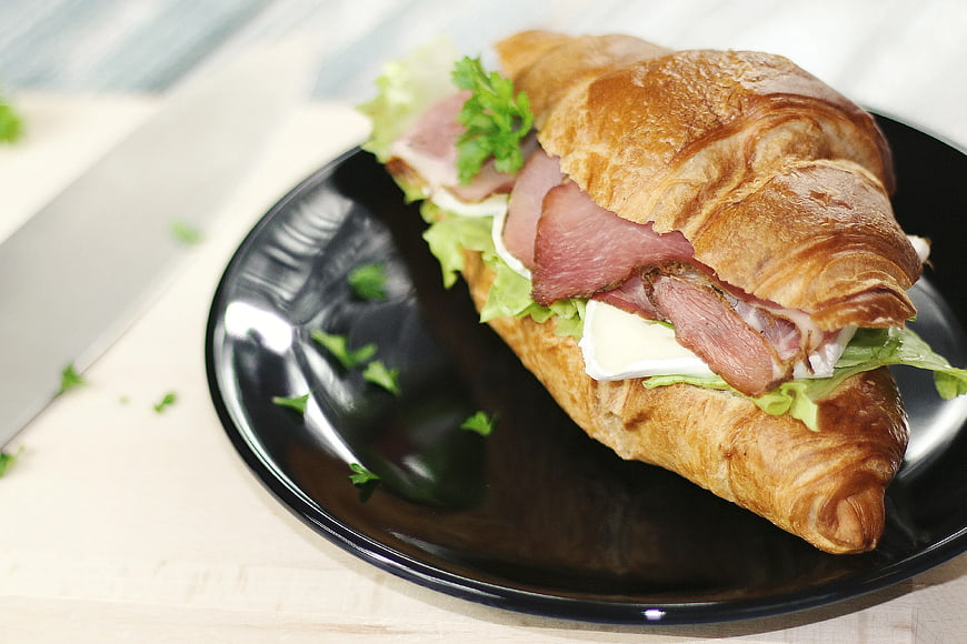 Ham and Cheese Croissant Sandwich on Black Plate