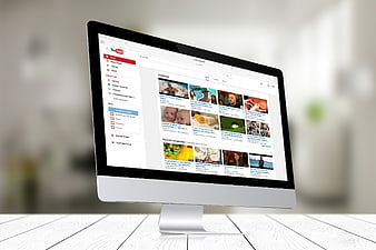 Apple iMac Desktop Computer Displaying YouTube Homepage Interface