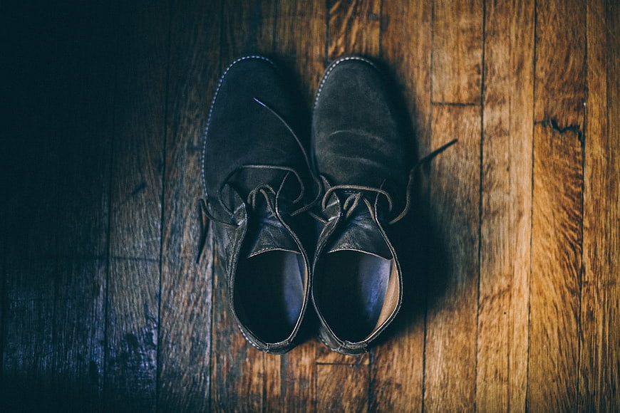 Vintage Black Suede Shoes on Wooden Floor