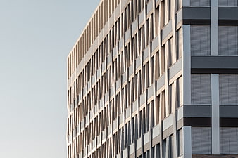 Modern geometric office building facade with beige and gray panels