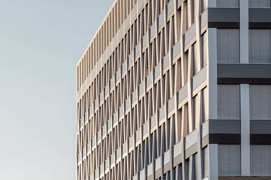 Modern geometric office building facade with beige and gray panels
