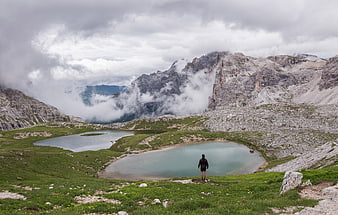Lone Hiker Overlooking Alpine Lakes in Dolomites
