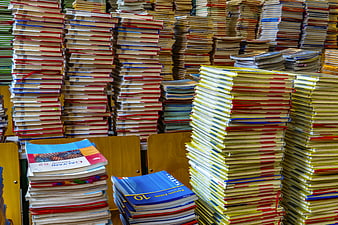 Large Stacks of School Textbooks and Notebooks in a Classroom