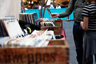 Couple browsing vinyl records at outdoor market stall