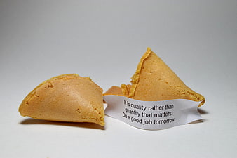 Broken fortune cookie with inspirational message on white background