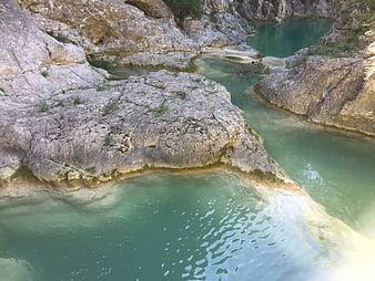 Turquoise river winding through rocky canyon landscape