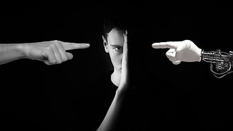 Man facing human and robotic pointing fingers in black and white