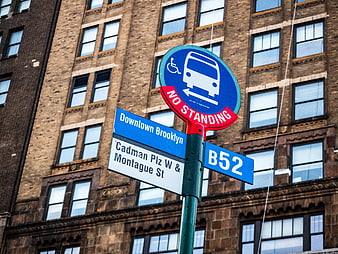 Brooklyn Bus Stop Sign on Brick Building Background