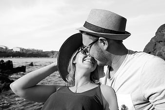 Romantic Black And White Portrait Of Young Couple Kissing On Beach