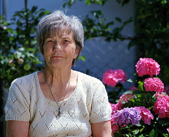 Portrait of elderly woman with gray hair in garden
