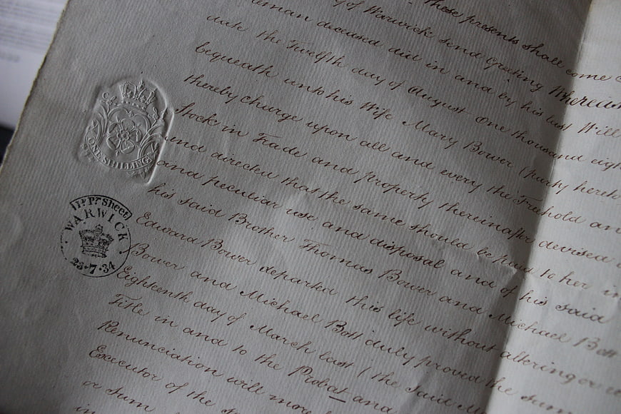 Close-up of vintage legal document with wax seal and stamp