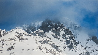 Majestic Snow-Covered Mountain Peaks with Clouds