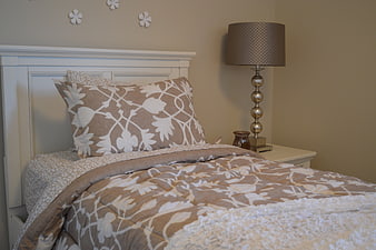 Cozy Bedroom Interior With Floral Bedding And Table Lamp