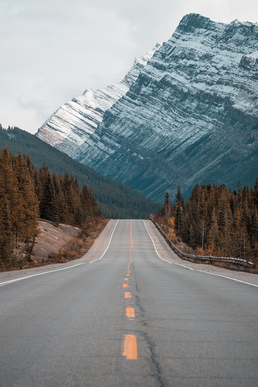 Empty Mountain Highway Road Leading to Snowy Peaks