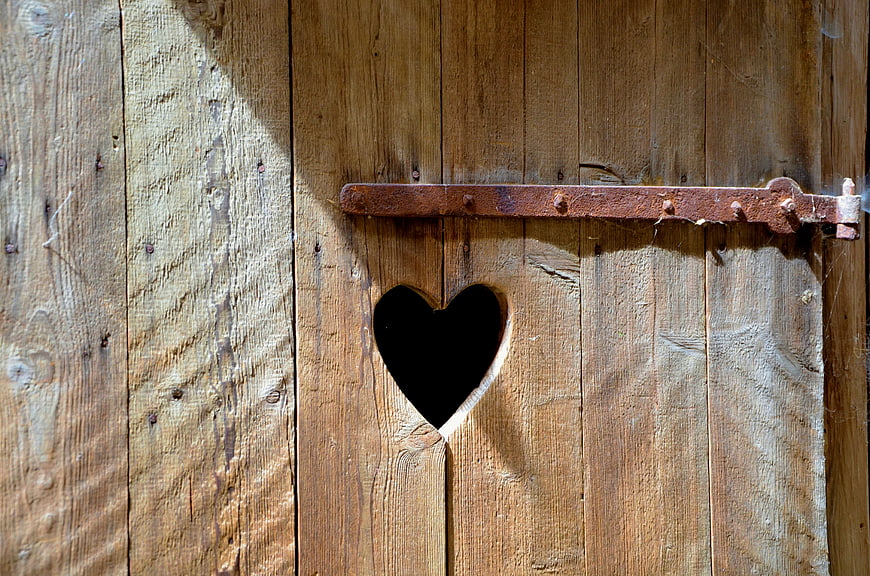Heart Cutout In Weathered Rustic Wooden Barn Door