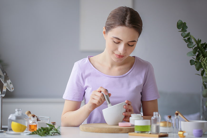 Woman mixing natural homemade face mask in kitchen