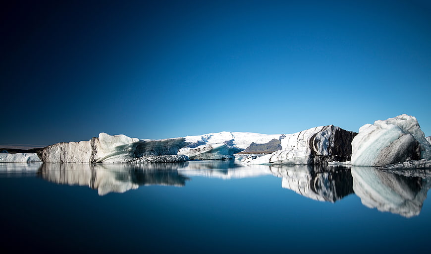 Serene Glacier Lagoon with Icebergs and Reflections